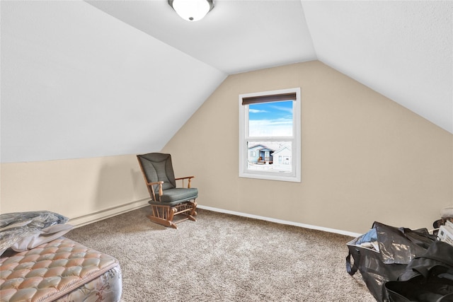 living area with baseboards, lofted ceiling, and carpet