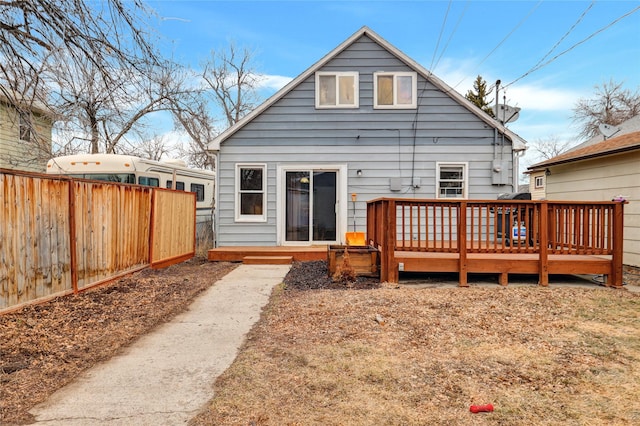 back of house with a deck and fence