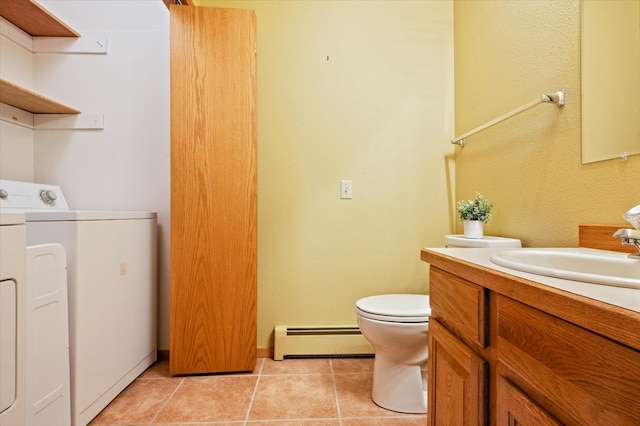 bathroom featuring vanity, washer / dryer, tile patterned flooring, toilet, and baseboard heating