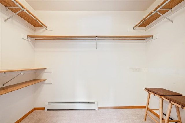 walk in closet with carpet flooring and a baseboard radiator