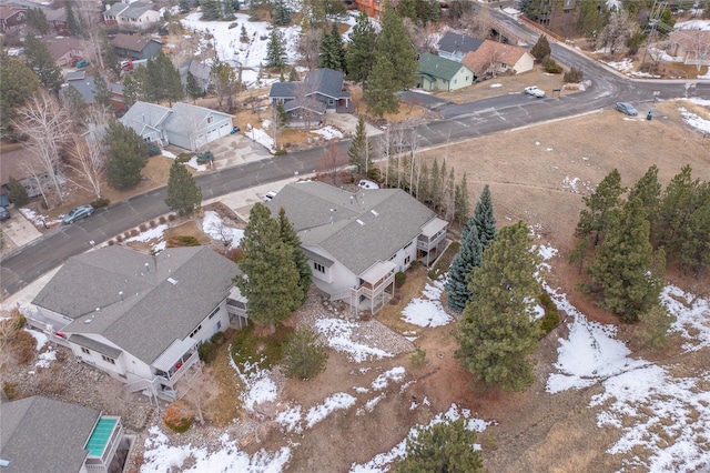 snowy aerial view with a residential view