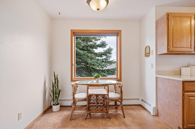 dining area featuring light tile patterned floors and baseboards