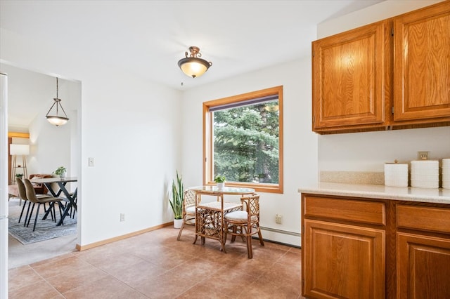 dining area featuring light tile patterned floors and baseboards