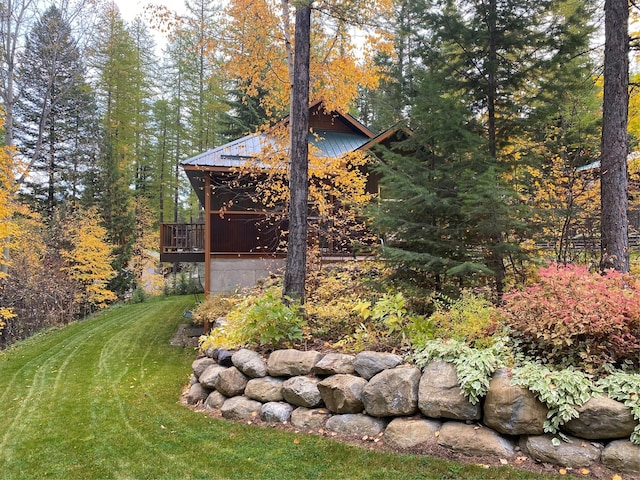 view of yard with a view of trees and a deck