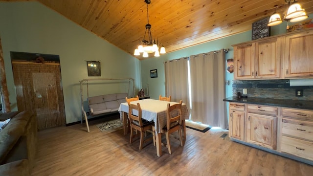 dining room with vaulted ceiling, light wood-style flooring, a notable chandelier, and wooden ceiling