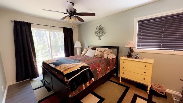 bedroom with a ceiling fan and baseboards