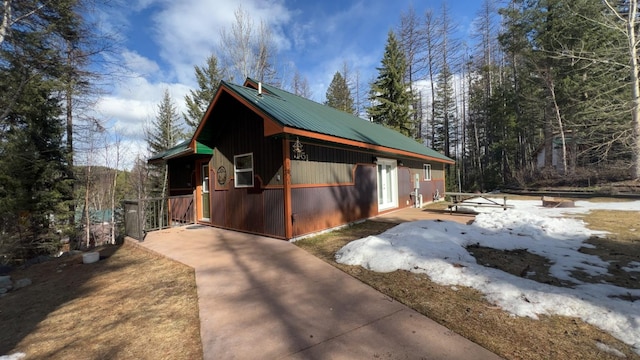 snow covered property with metal roof