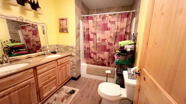 full bath with shower / bathtub combination with curtain, toilet, tile walls, and a sink