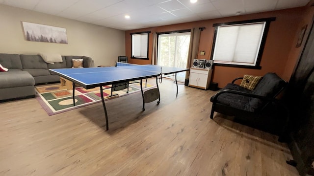 rec room featuring a paneled ceiling and light wood-style flooring