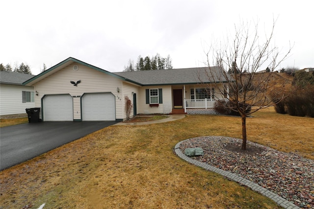 ranch-style home with driveway, covered porch, a shingled roof, a front lawn, and a garage