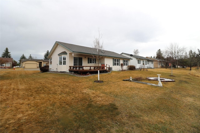 back of house with an outbuilding, central air condition unit, a lawn, and a wooden deck