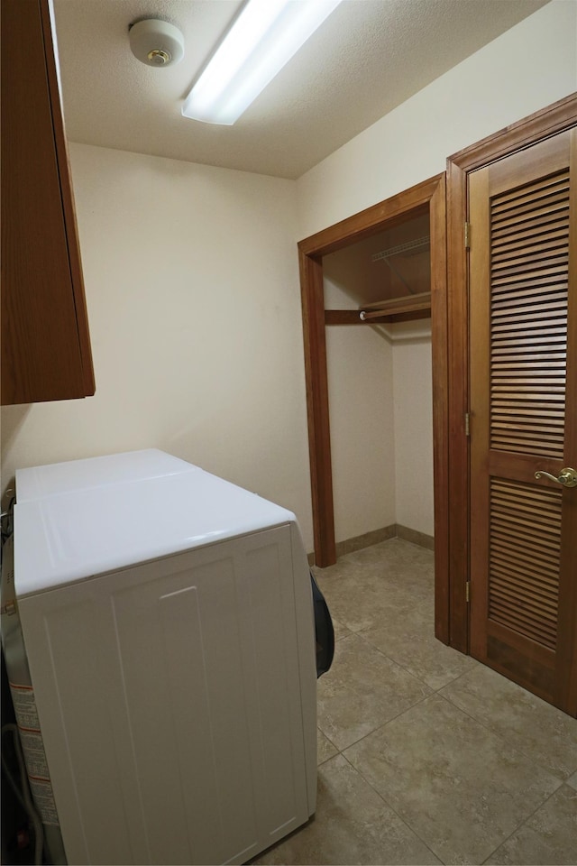 washroom featuring cabinet space and washer / clothes dryer