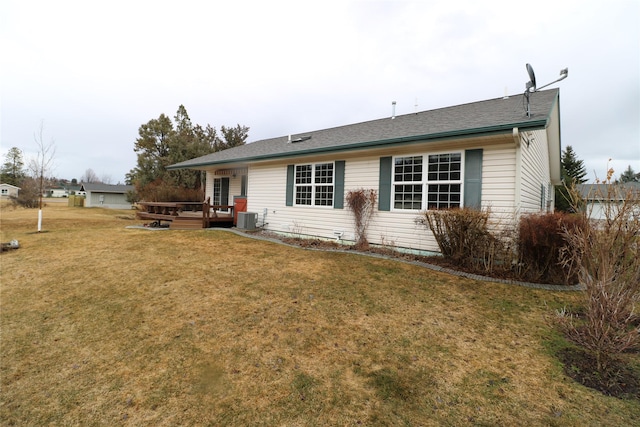 rear view of house featuring a yard, central AC, and a deck