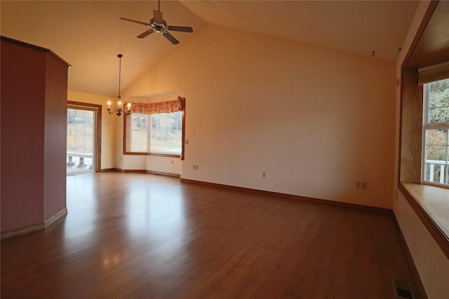 empty room with visible vents, ceiling fan with notable chandelier, baseboards, and wood finished floors