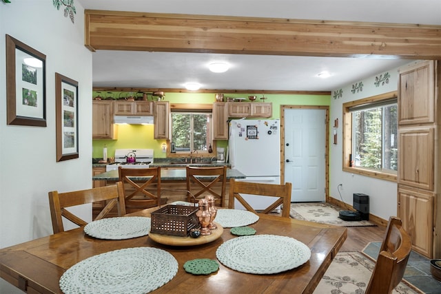 dining area with light wood-style floors and baseboards