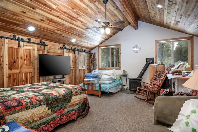 bedroom featuring carpet, lofted ceiling with beams, a wood stove, a barn door, and wooden ceiling