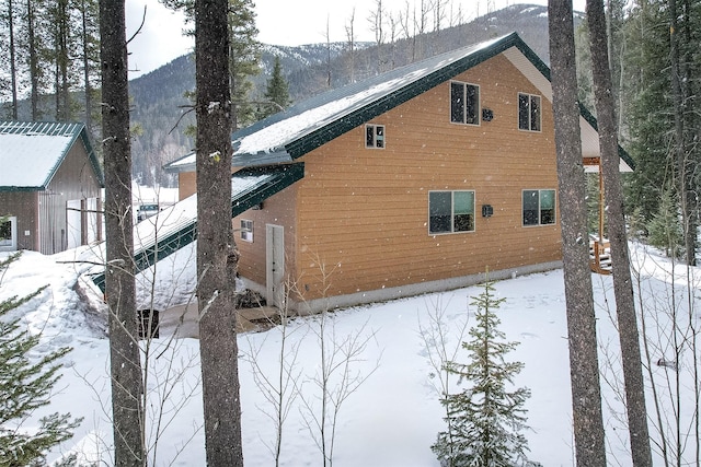 snow covered property featuring a mountain view