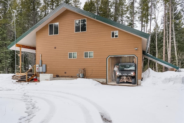 view of snow covered rear of property