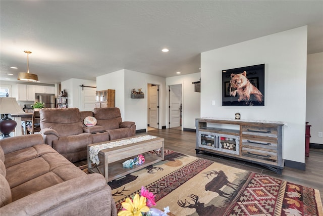 living area featuring recessed lighting, baseboards, and dark wood finished floors