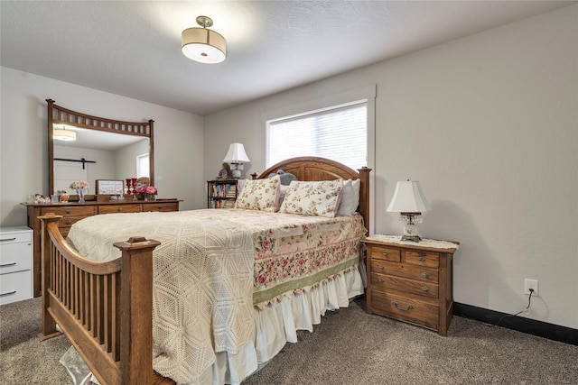 carpeted bedroom featuring baseboards