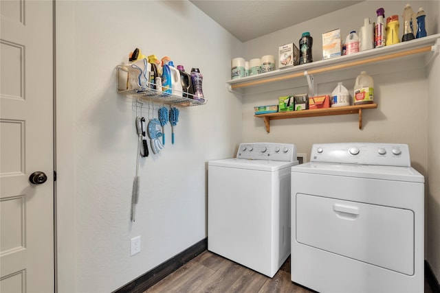 laundry room featuring laundry area, separate washer and dryer, dark wood-style flooring, and baseboards