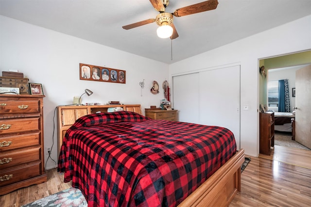 bedroom with a closet, light wood-style floors, and ceiling fan