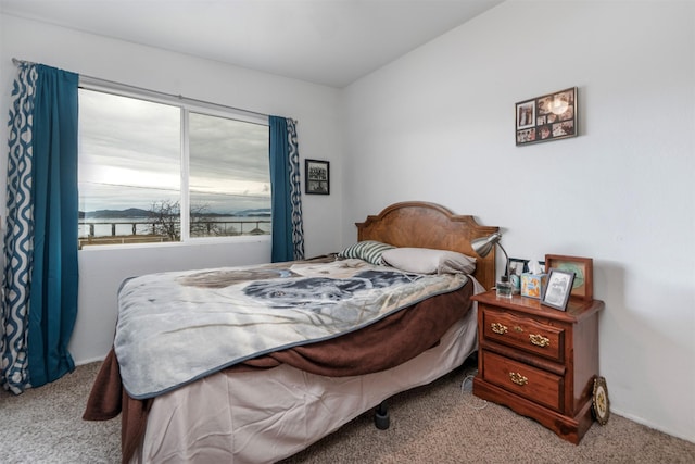 bedroom with vaulted ceiling and carpet