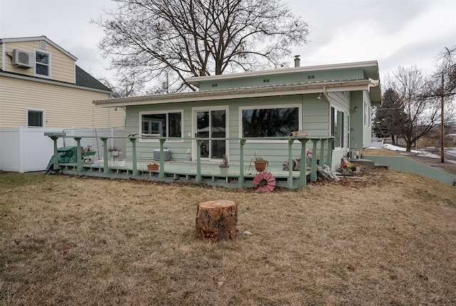 back of house with a yard and a wooden deck