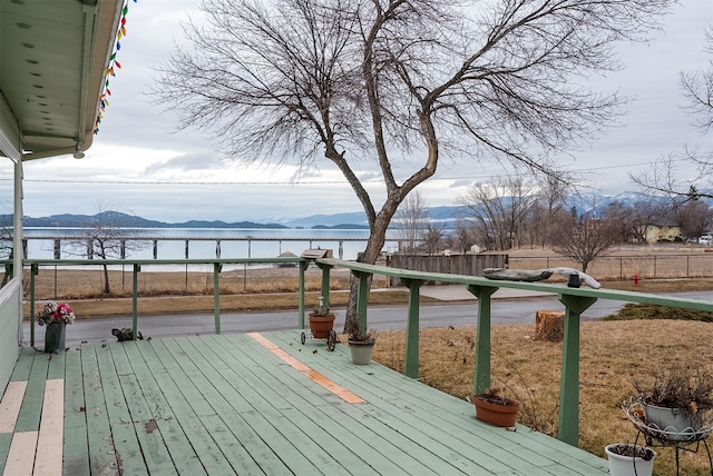 wooden deck featuring a water and mountain view