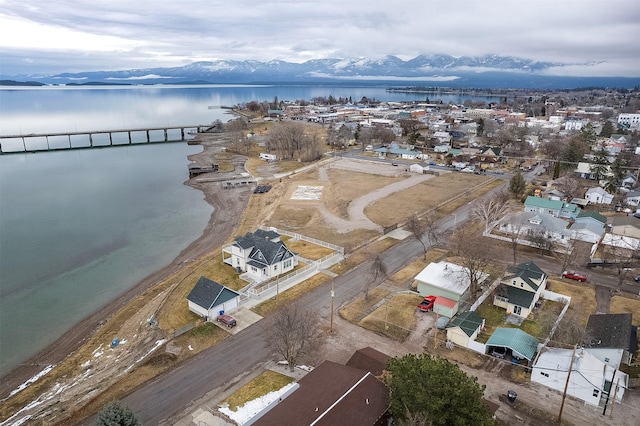 birds eye view of property with a water and mountain view