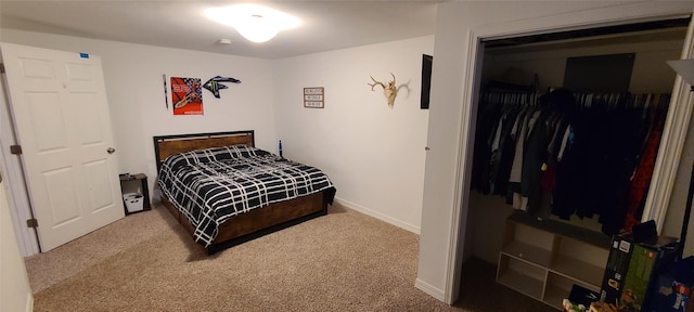 carpeted bedroom featuring a closet and baseboards