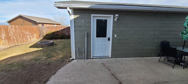 view of outdoor structure with fence and an outdoor fire pit