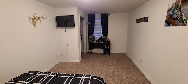 carpeted bedroom featuring baseboards