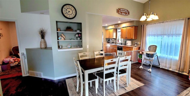 dining room with built in features, baseboards, visible vents, dark wood finished floors, and a chandelier