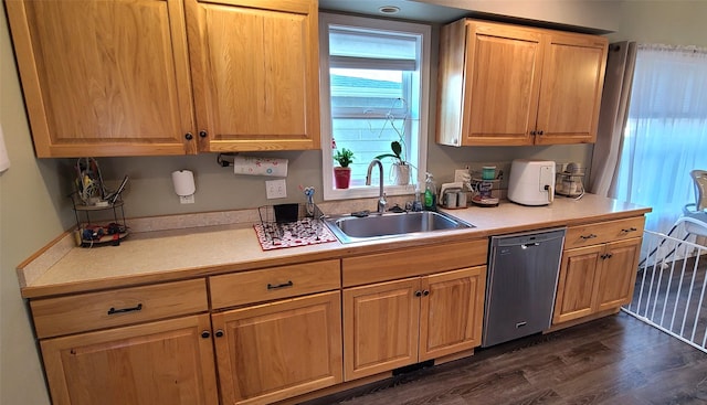 kitchen featuring a sink, dark wood-style flooring, light countertops, and stainless steel dishwasher