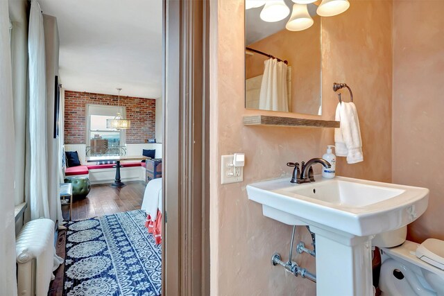 131 S Higgins Ave Unit 7-2, Missoula, MT 59802 - bathroom featuring radiator, wood finished floors, and a shower with shower curtain