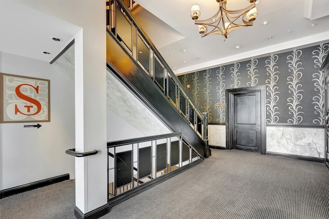 stairs featuring wallpapered walls, a chandelier, ornamental molding, carpet flooring, and recessed lighting