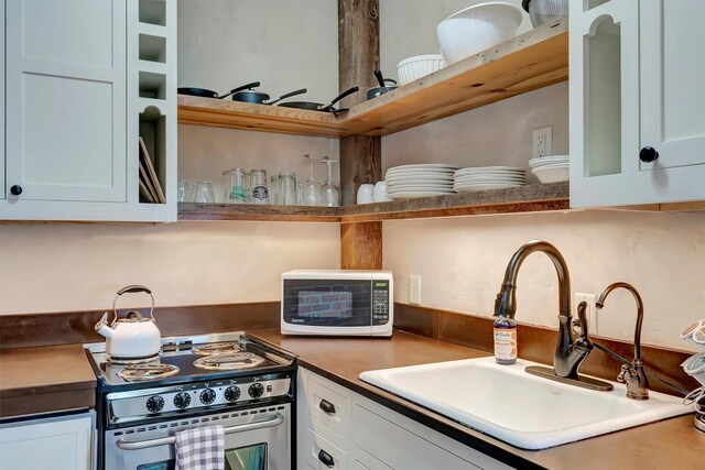 131 S Higgins Ave Unit 7-2, Missoula, MT 59802 - kitchen featuring stainless steel range with electric cooktop, white microwave, white cabinets, and open shelves