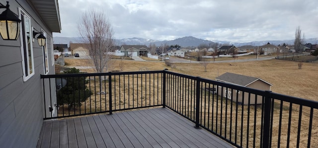 wooden terrace featuring a mountain view and a residential view