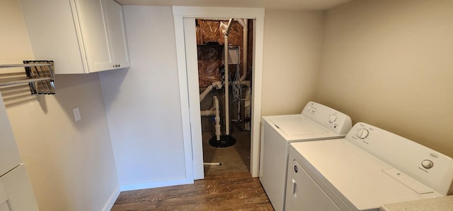 laundry room with cabinet space, washing machine and dryer, dark wood-type flooring, and baseboards