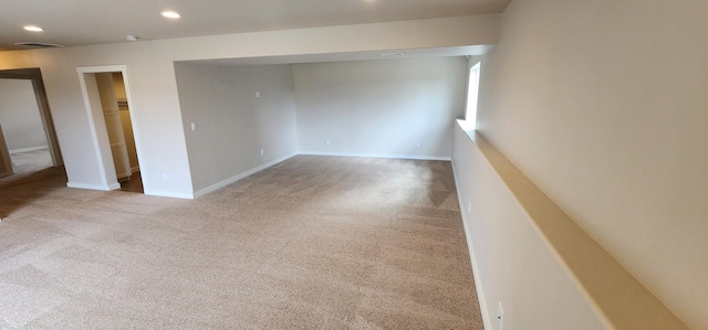 carpeted spare room with recessed lighting and baseboards