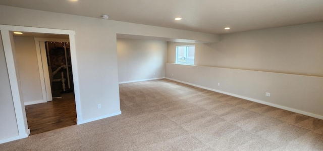 carpeted empty room featuring recessed lighting and baseboards