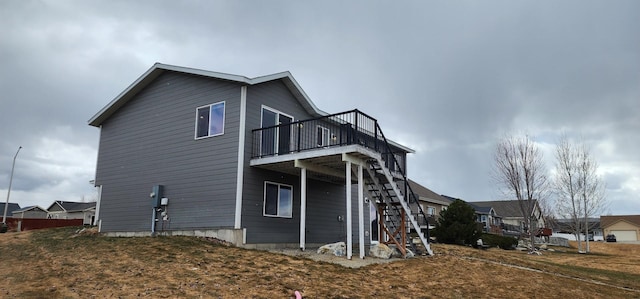 view of property exterior featuring a deck and stairs