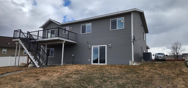 rear view of property with stairway, central AC unit, fence, a yard, and a deck