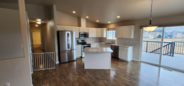 kitchen with visible vents, a sink, appliances with stainless steel finishes, decorative backsplash, and light stone countertops