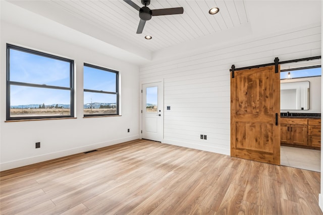 spare room with visible vents, wooden ceiling, light wood finished floors, a raised ceiling, and ceiling fan