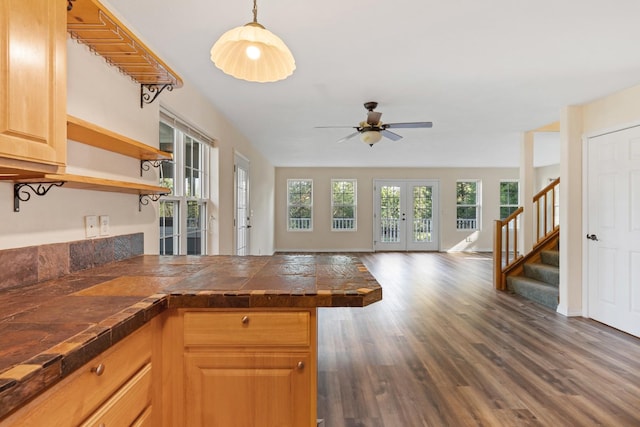 kitchen featuring dark wood-type flooring, open shelves, open floor plan, french doors, and a peninsula