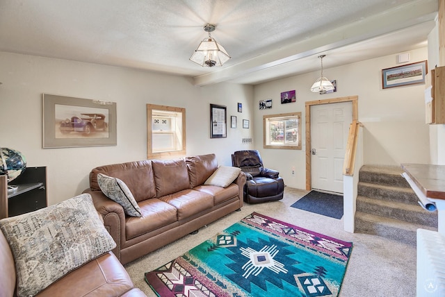 living room featuring stairs, beam ceiling, carpet, and a textured ceiling