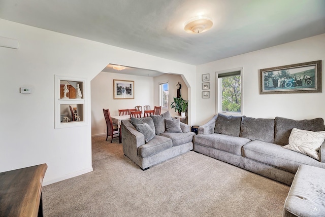 living room featuring baseboards and carpet