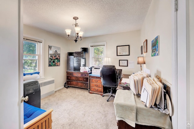 office area featuring radiator, baseboards, a textured ceiling, light carpet, and a chandelier